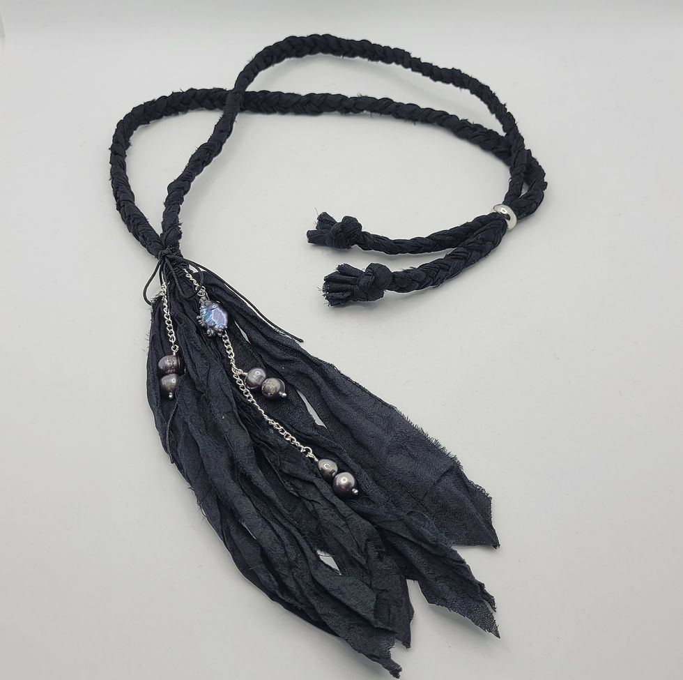 Thumbnail: Black plaited sari silk necklace with matching tassel and natural peacock pearl beads at the front.  