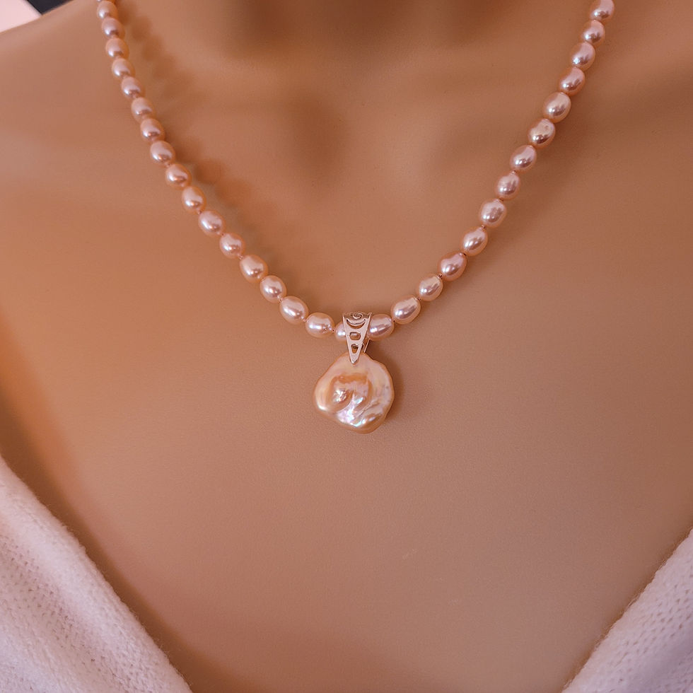 Thumbnail: Peach cultured pearl and sterling silver necklace displayed on a mannequin