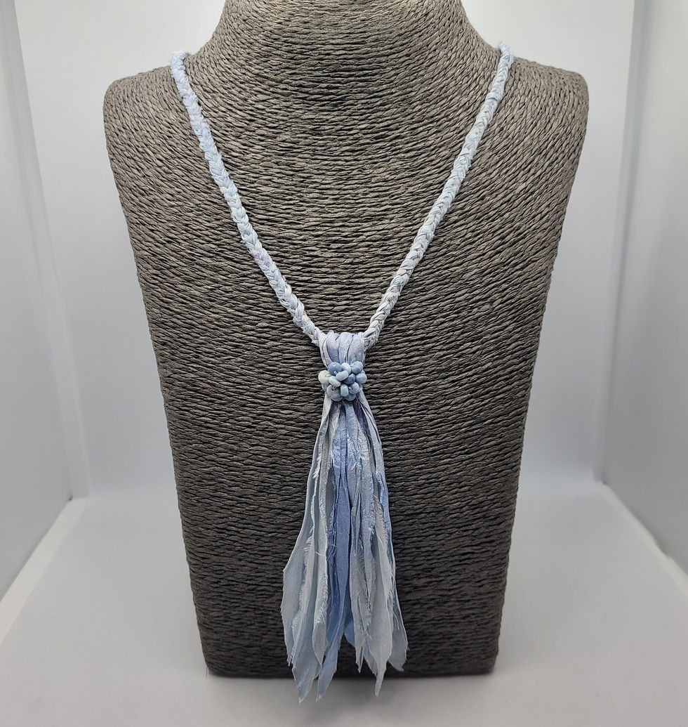 Thumbnail: Blue plaited sari silk necklace with tassel, displayed on grey necklace bust