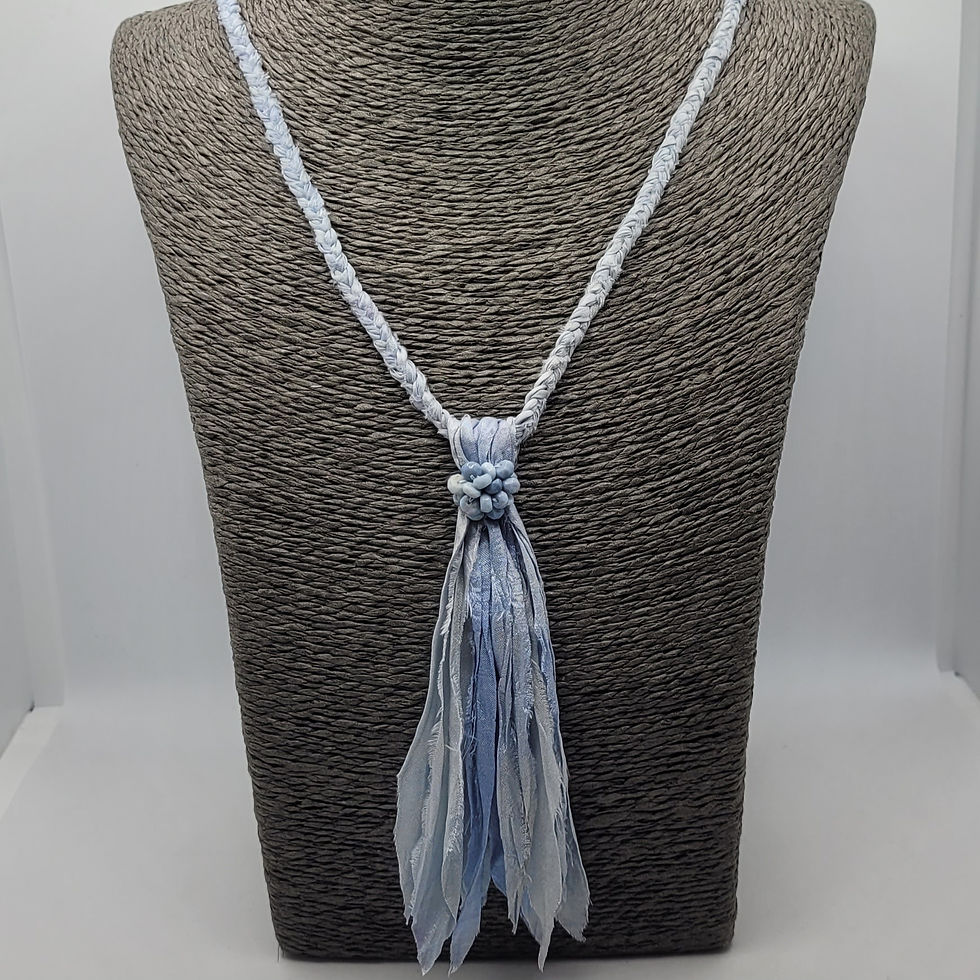 Thumbnail: Blue plaited sari silk necklace with tassel, displayed on grey necklace bust