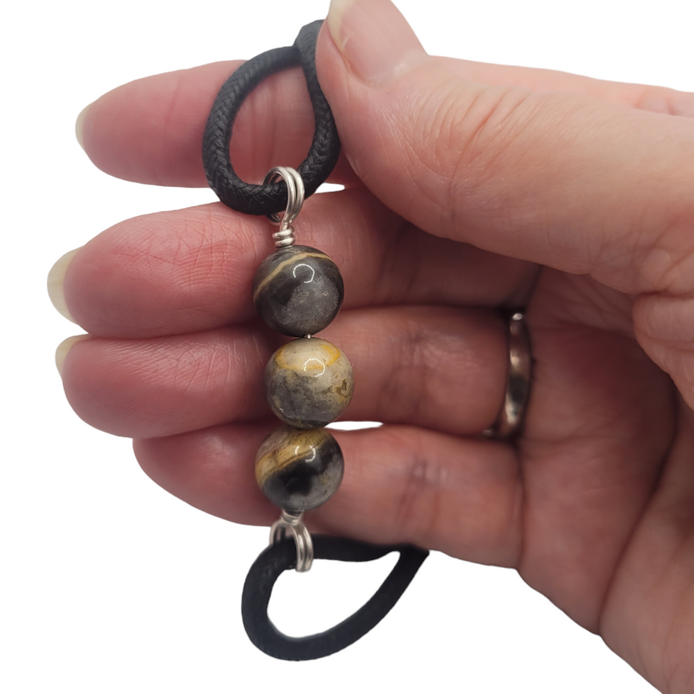 Thumbnail: Mens cord bracelet with crazy lace agate, displayed on hand