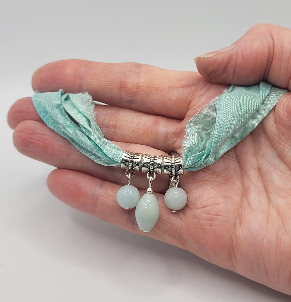 Thumbnail: Sari silk necklace with Amazonite beads, displayed in hand