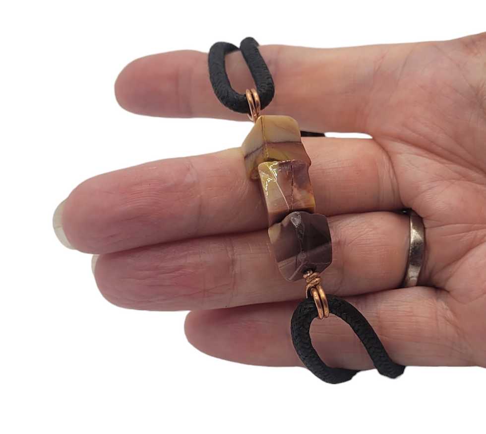 Thumbnail: Mens cord bracelet with 3 mookite beads, displayed on hand