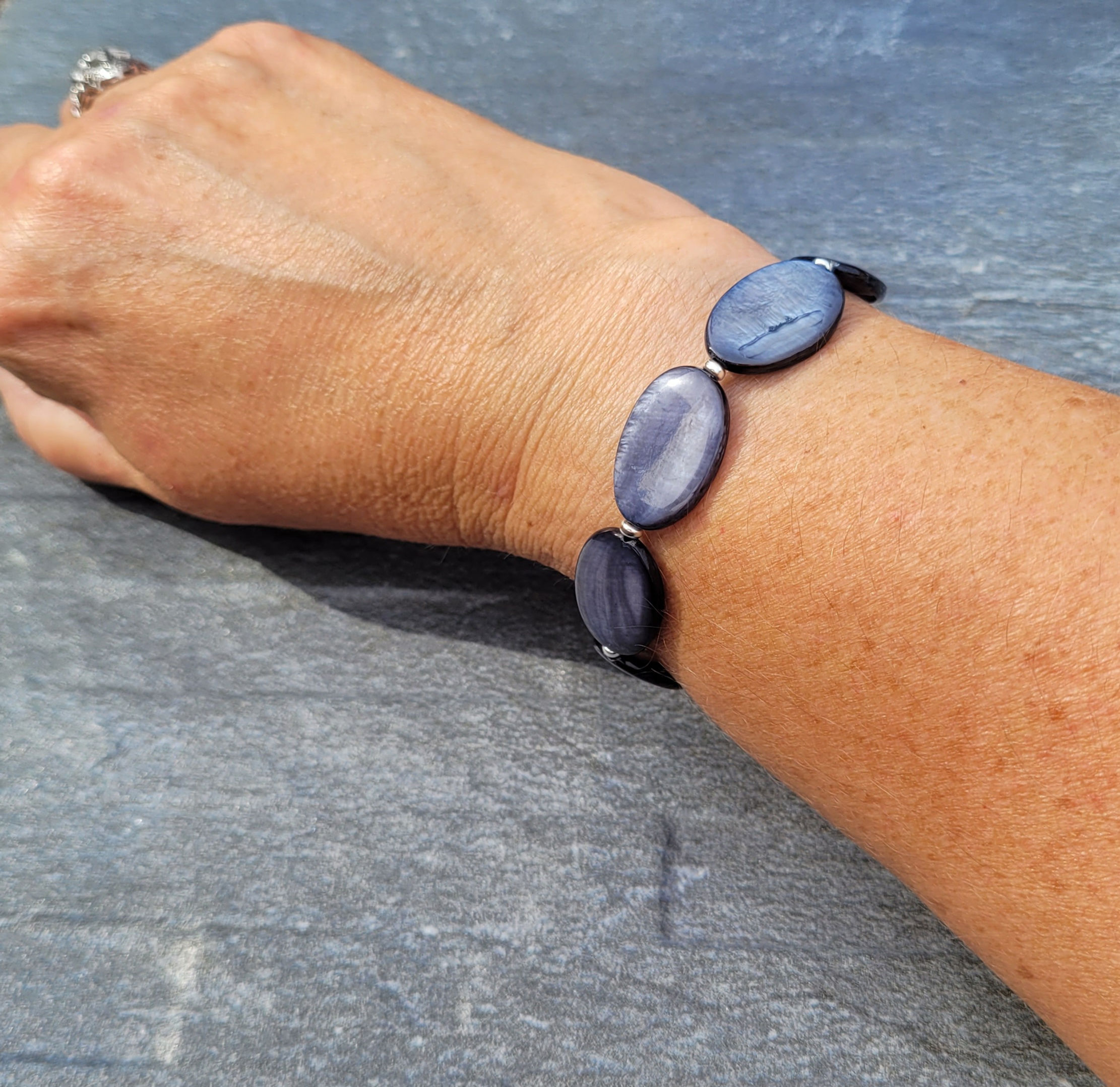 Black Mother of Pearl stretchy bracelet displayed on wrist