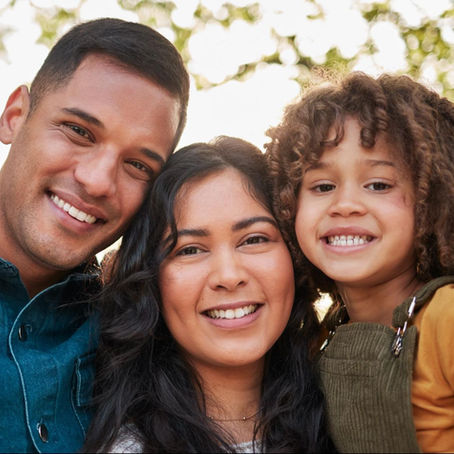 Smiling family portrait representing owner financing for first-time land buyers achieving homeownership
