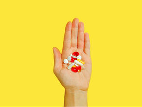 person showing medications on palm, representing the goal of improving clinical medication access
