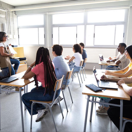 class in progress, with teacher and students in a discussion
