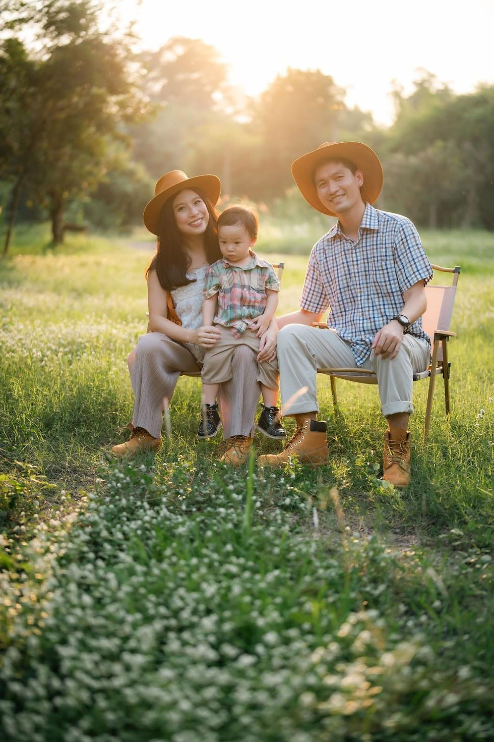 Happy family standing on their Texas land at sunset, symbolizing pride and new beginnings.