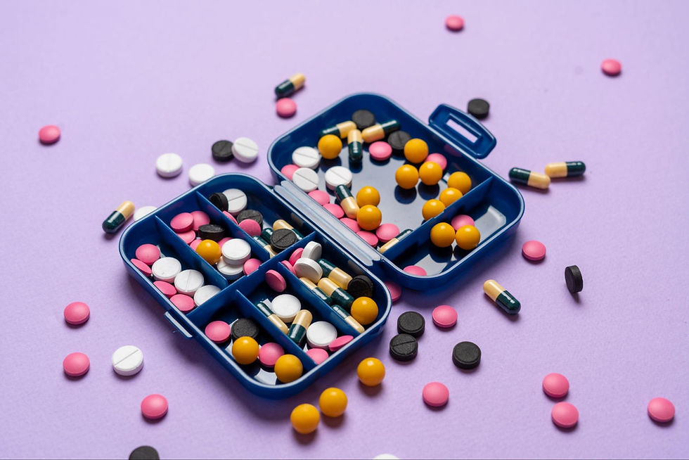 medicine organizer with lots of colorful medications in pill and capsule form