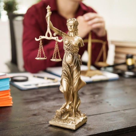 statue of Lady Justice on table, representing the need for victim services and prosecution funding