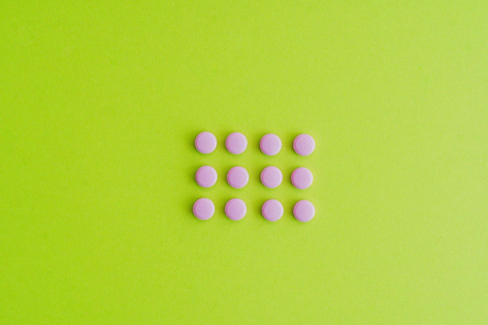Medications arranged on a green surface, illustrating how scheduling drugs influences classification, medical use, and safe patient access.