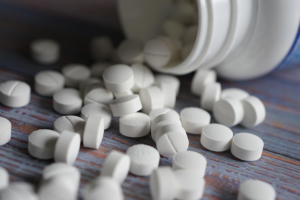 white tablets spilling out of a container