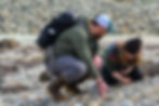 Austin Kief and Sam Strand look for garnets on the shore of Mendenhall River on Saturday, July 11, 2026. (Jasz Garrett / Juneau Independent)