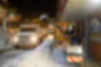A plow moves snow into a dump truck outside City Hall on Wednesday, Jan. 7, 2026. (Jasz Garrett / Juneau Independent)