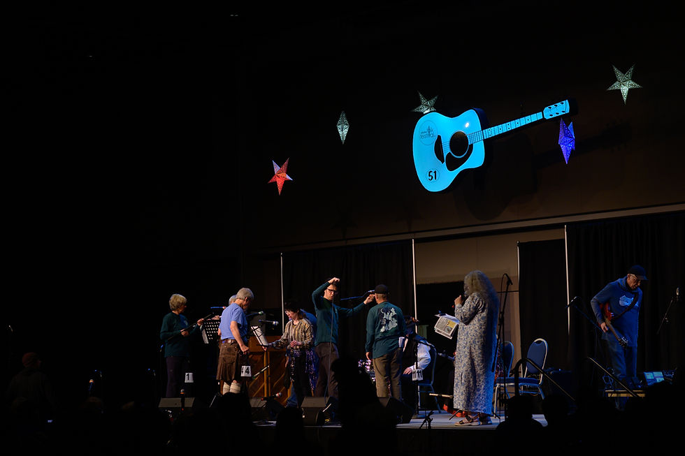 The stage crew switches a set on the main stage of the Alaska Folk Festival at Centennial Hall on Monday, April 6, 2026. (Jasz Garrett / Juneau Independent)