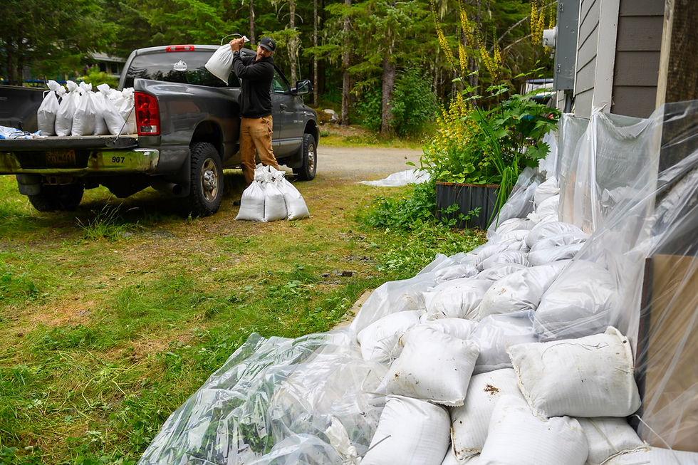 Logan Shaul lines his View Drive property with sandbags on Tuesday, Aug. 11, 2026. (Jasz Garrett / Juneau Independent)