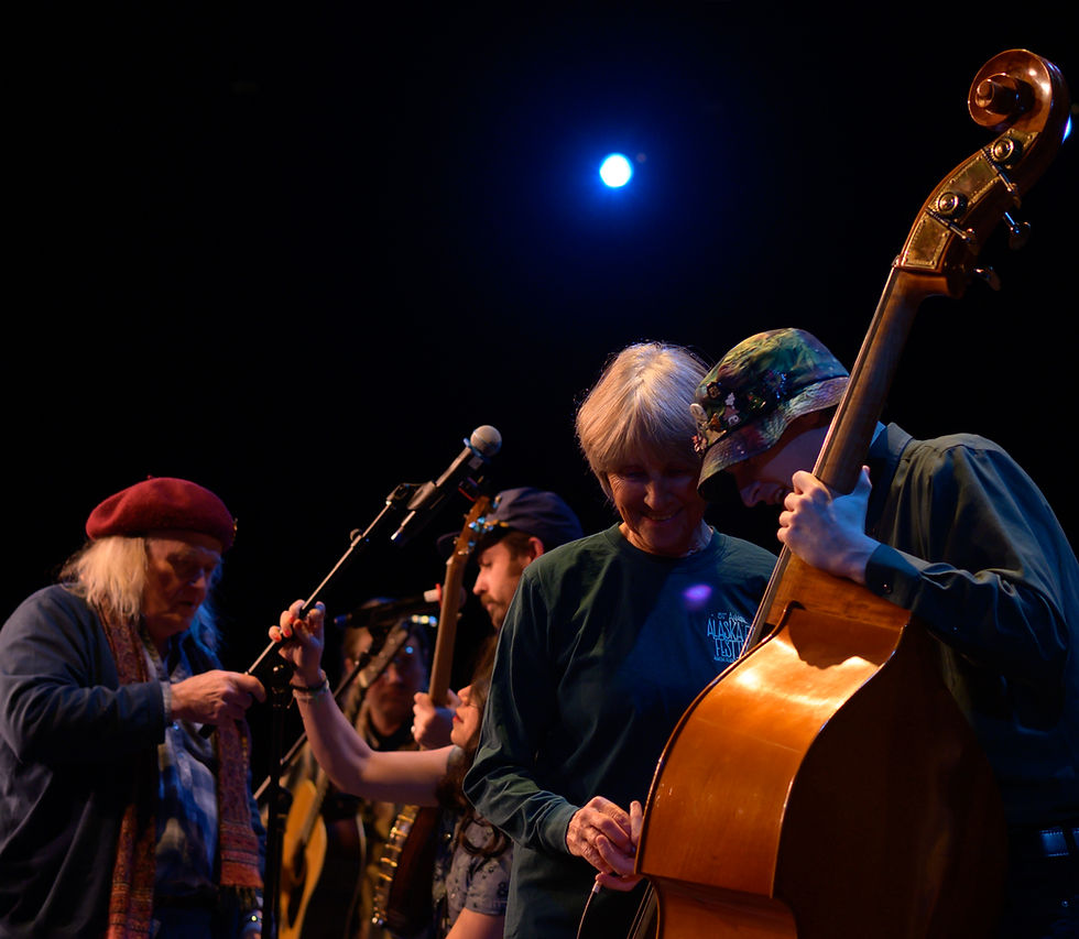Jan Beauchamp helps Sam Bluett of Steady Going set up on stage on Monday, April 6, 2026. (Jasz Garrett / Juneau Independent)