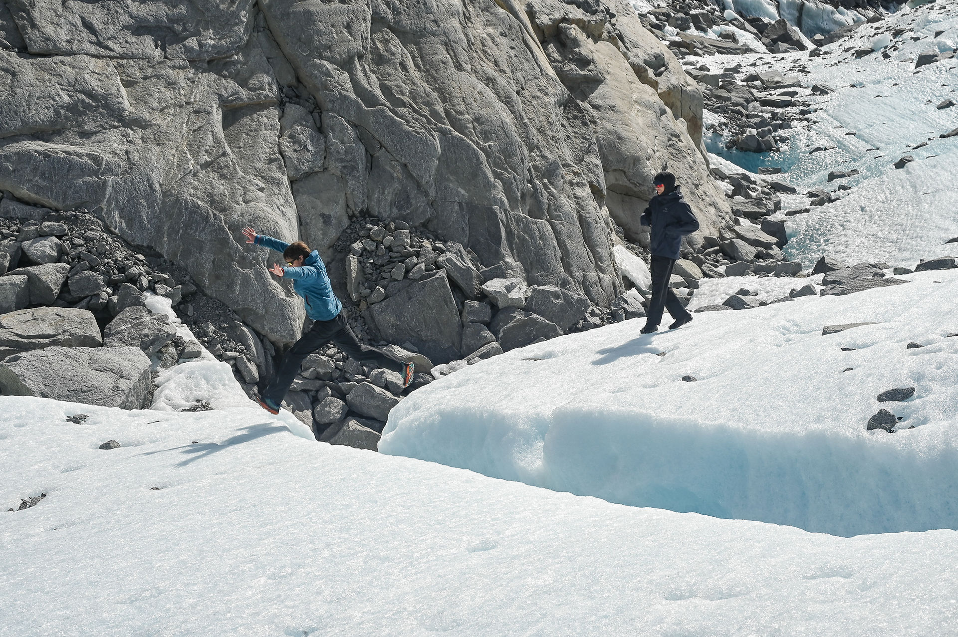 Eran Hood jumps over a crevasse of the overflow channel on Aug. 13, 2025.