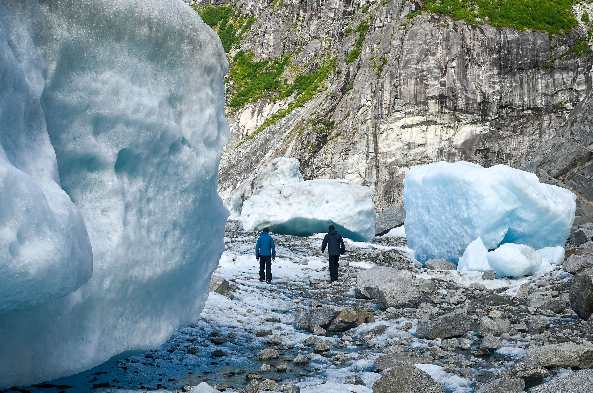 Eran Hood and Sean Fagan walk back toward the basin through the overflow channel on Aug. 13, 2025.