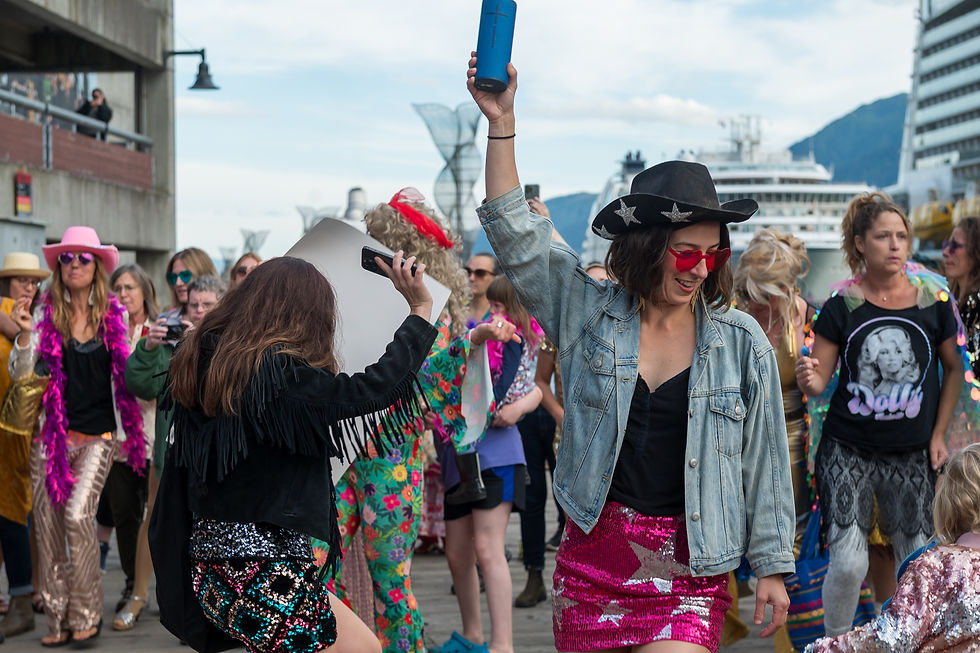 People dance on the downtown cruise ship docks to Dolly Parton's music on Friday, Aug. 28, 2026. (Jasz Garrett / Juneau Independent)