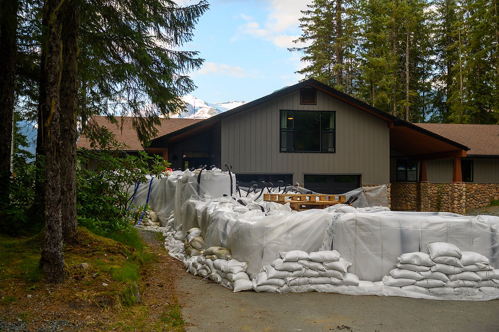 Kim Peterson's View Drive home is seen behind a wall of sandbags on Tuesday, Aug. 11, 2026. (Jasz Garrett / Juneau Independent)