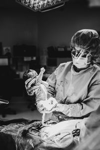 black and white doctor delivering a baby