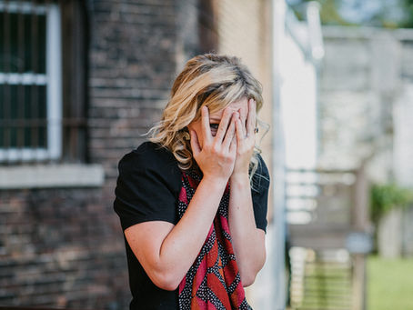 Julie hiding behind her palms, expressing a feeling of awkwardness