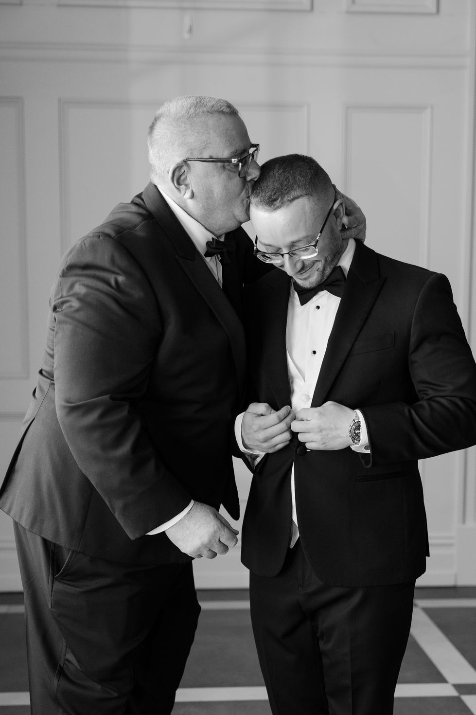 Groom on his wedding day with family members. 