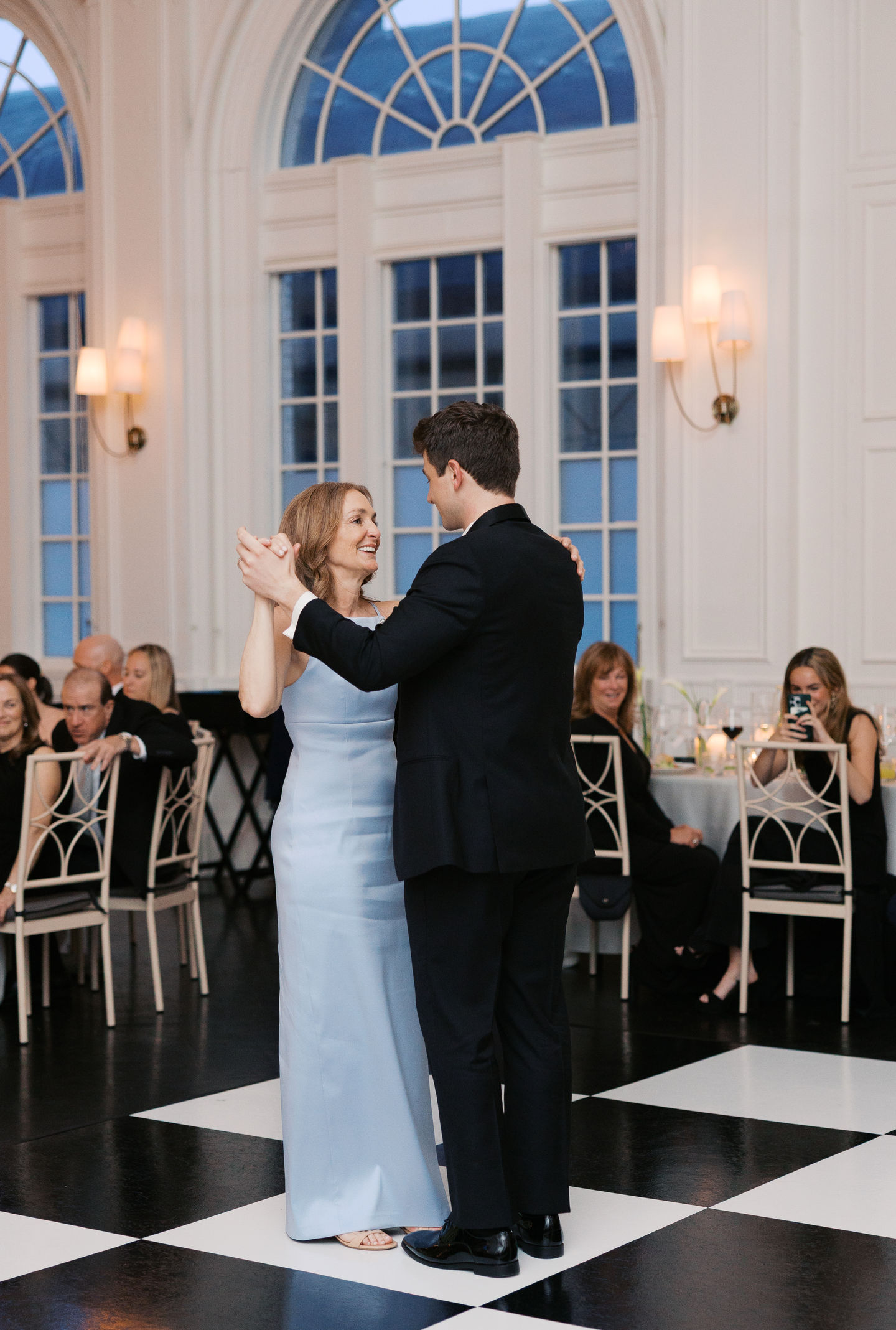 Couple dancing at an elegant indoor event.