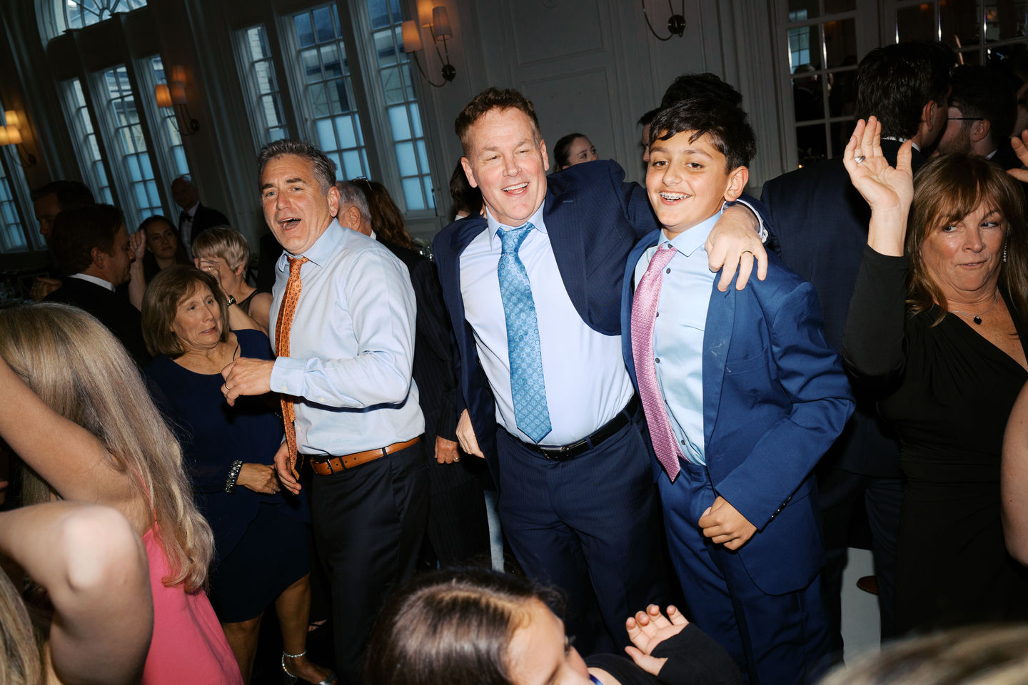 Group of people dancing at an event.