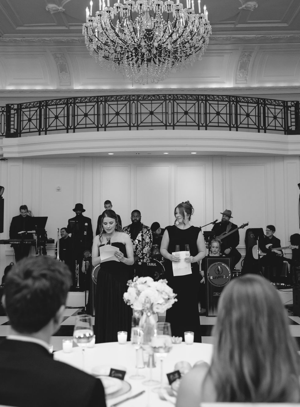 Black and white event with musicians and speakers.