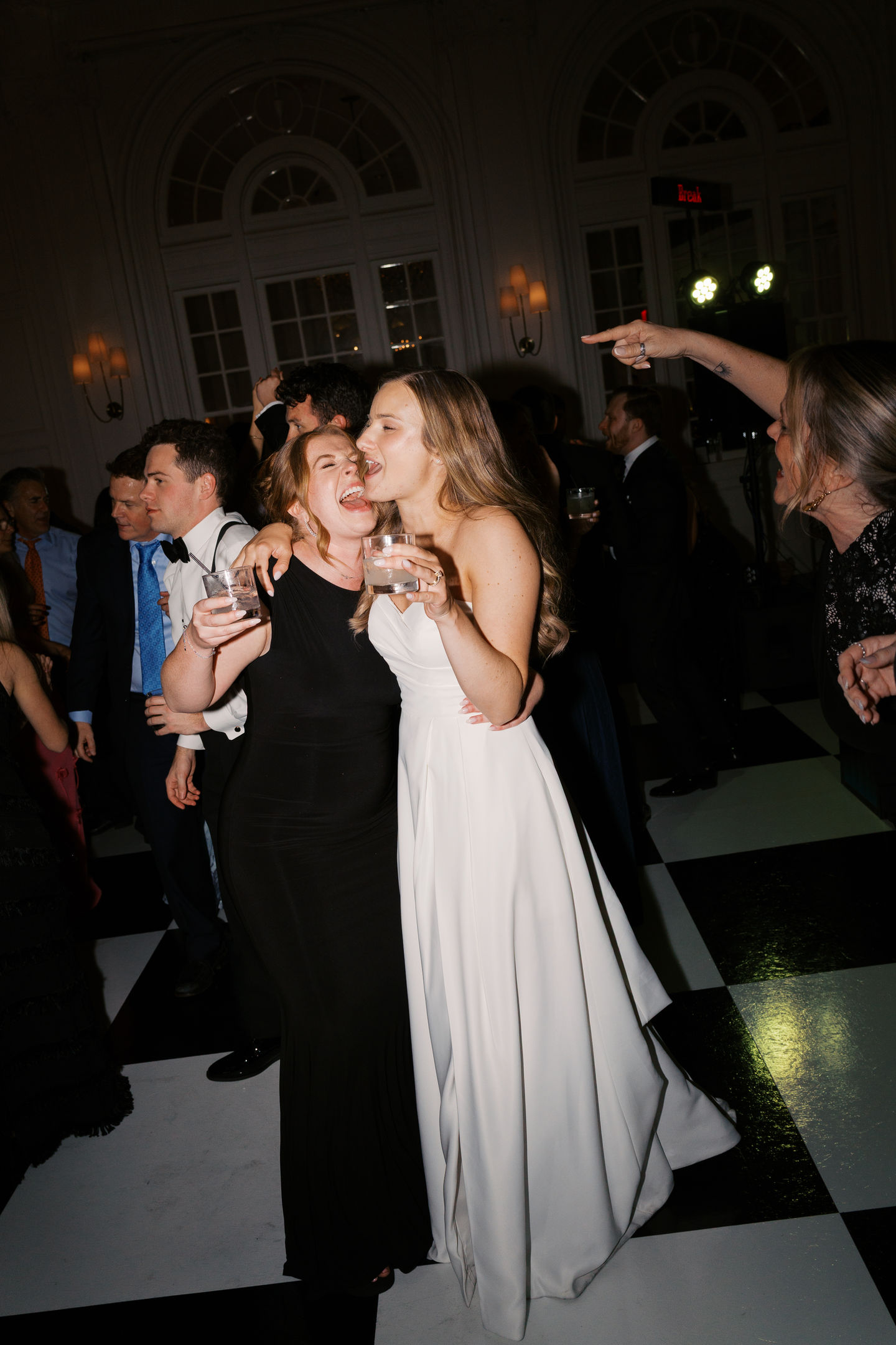 Two people joyfully dancing at an event.
