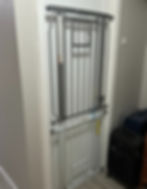 Two gates are attached, on on top of the other, in a doorway