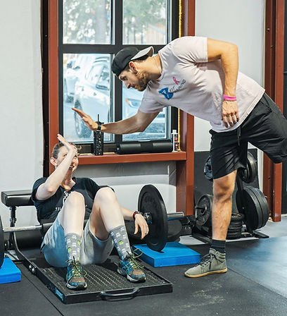 Trainer supporting client with a high five