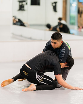 Grapplers practice chokes during no-gi BJJ class