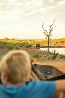 Child at the lodge watching an elephant at the waterhole at Royal Madikwe - Safari Lodge Photographer and Videographer Content Creator