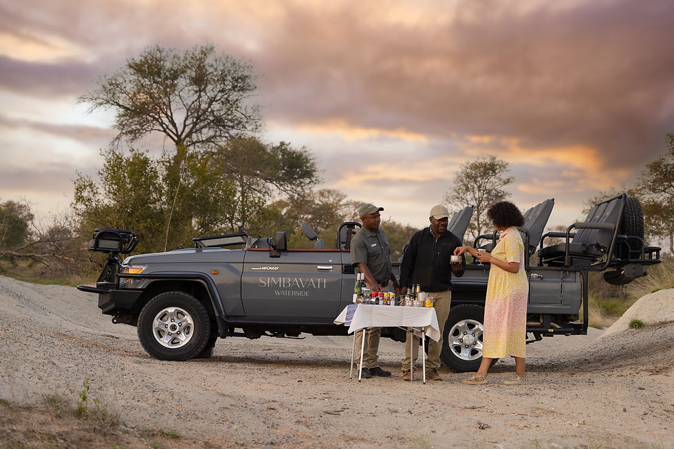Guests enjoying a sundowner stop on safari in Klaserie Private Nature Reserve - Safari Travel Agency