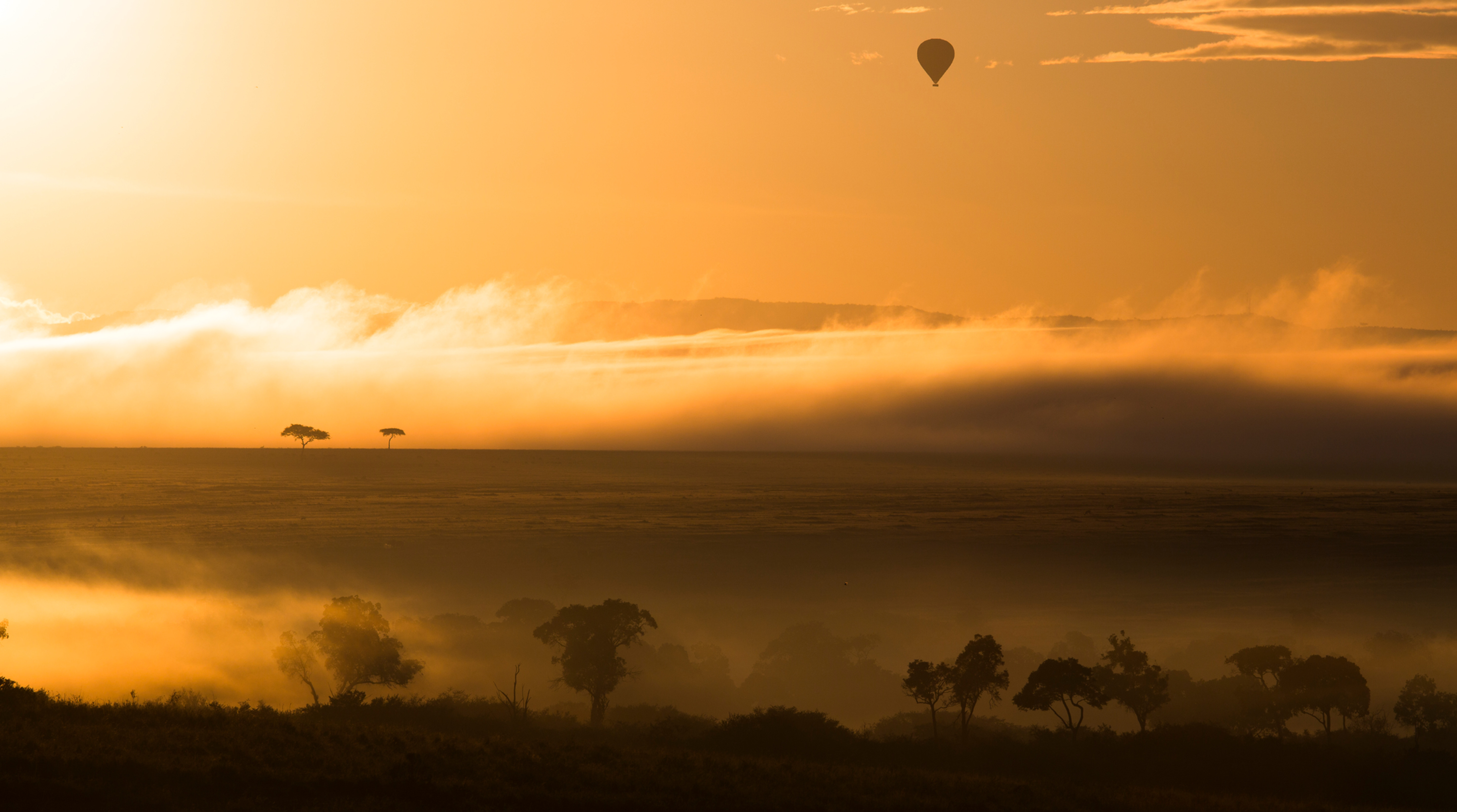 Incredible view of the Masai Mara as a hot air balloon safari goes over the plains.