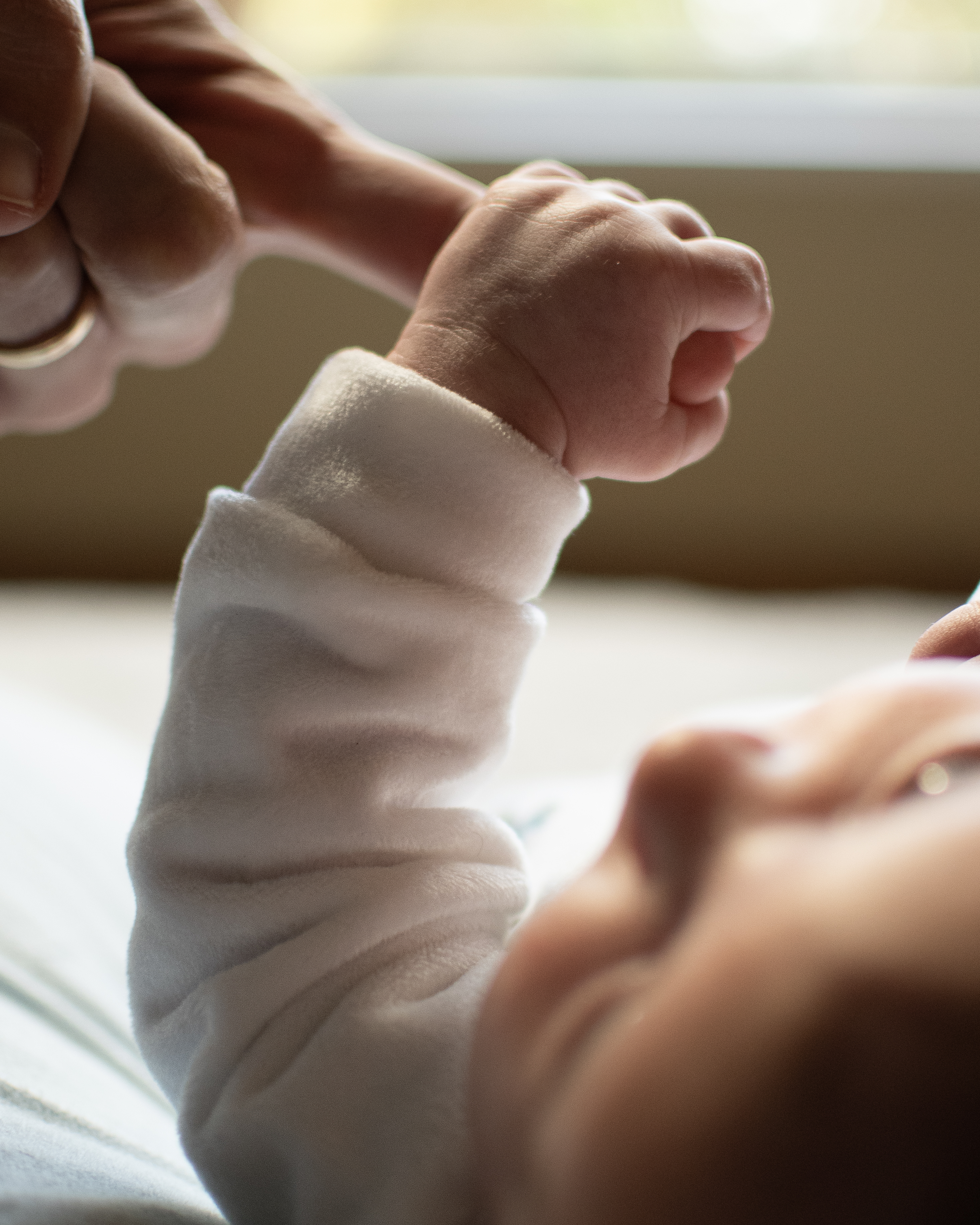 Timeless photo of a baby holding his dad's finger - Newborn Photography done by Gianni Creative Studio in North Riding, Gauteng, South Africa