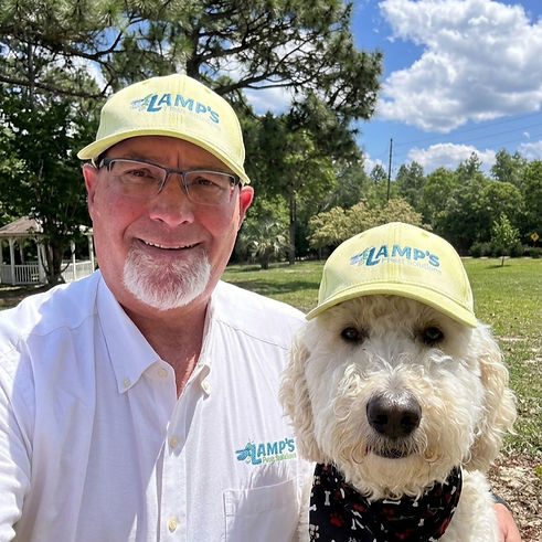Rick Lamp and his dog Moab wearing Lamp's Pest Solutions caps, owners of Lamp's Pest Solutions in Lexington SC