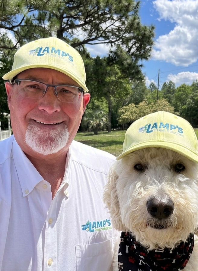Rick Lamp and his dog Moab wearing Lamp's Pest Solutions caps, owners of Lamp's Pest Solutions in Lexington SC