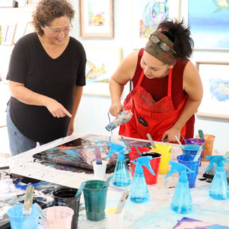 image of Vanessa Spittler teaching a pour art class at the gallery owned by Melissa Mitchell on Padre Island