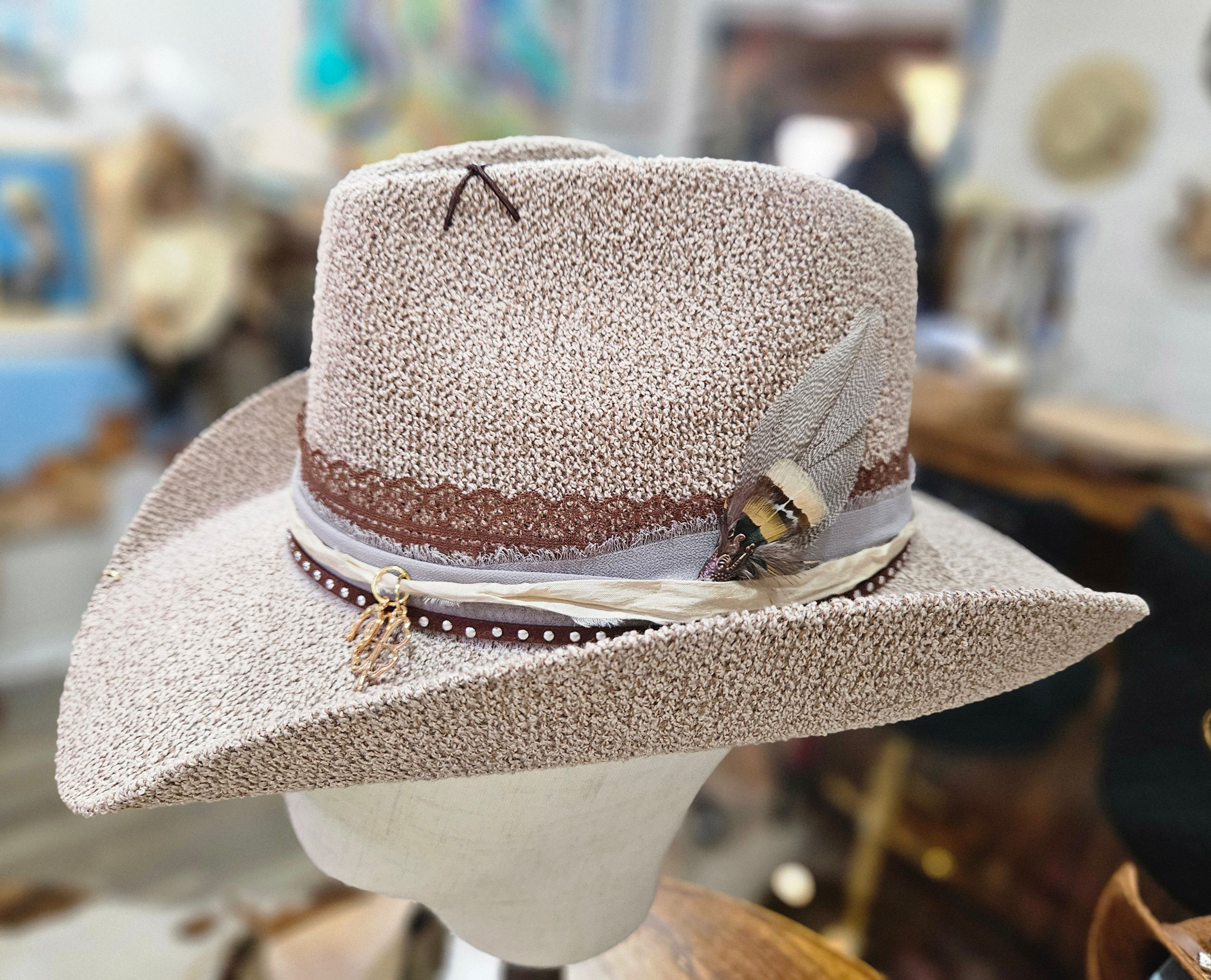 Custom women’s hat called The Morgan Leather & Lace by Evoke Signature featuring leather band, lace, charms, feather detail,