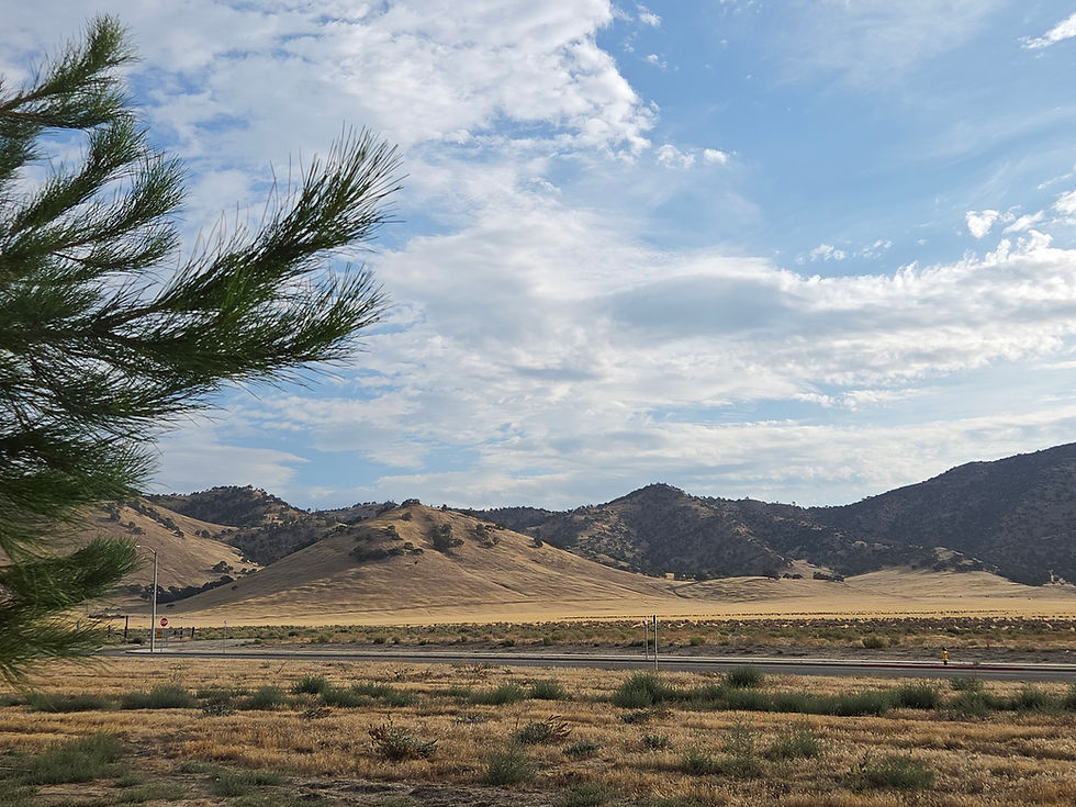 California mountain landscape beneath a blue sky with scattered clouds