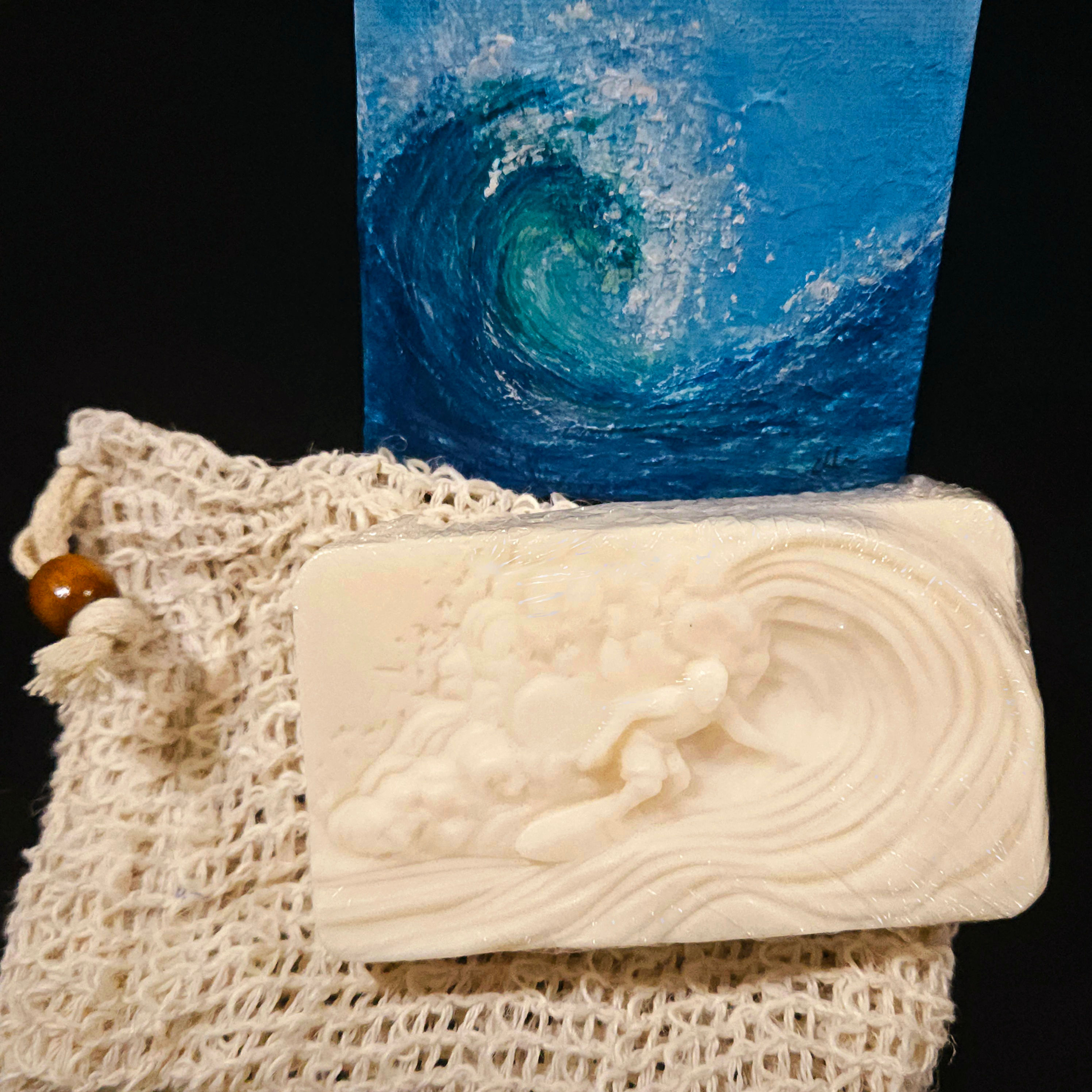Wave Rider Soap by Mermaid Soap Co. with ocean wave design and Coastal Wood & Spice fragrance displayed with sisal bag
