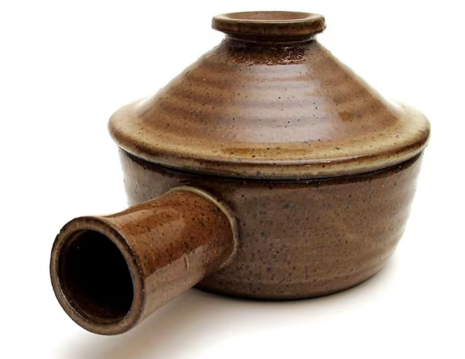 Small ceramic baking dish with lid used for single-serve chocolate dessert preparation