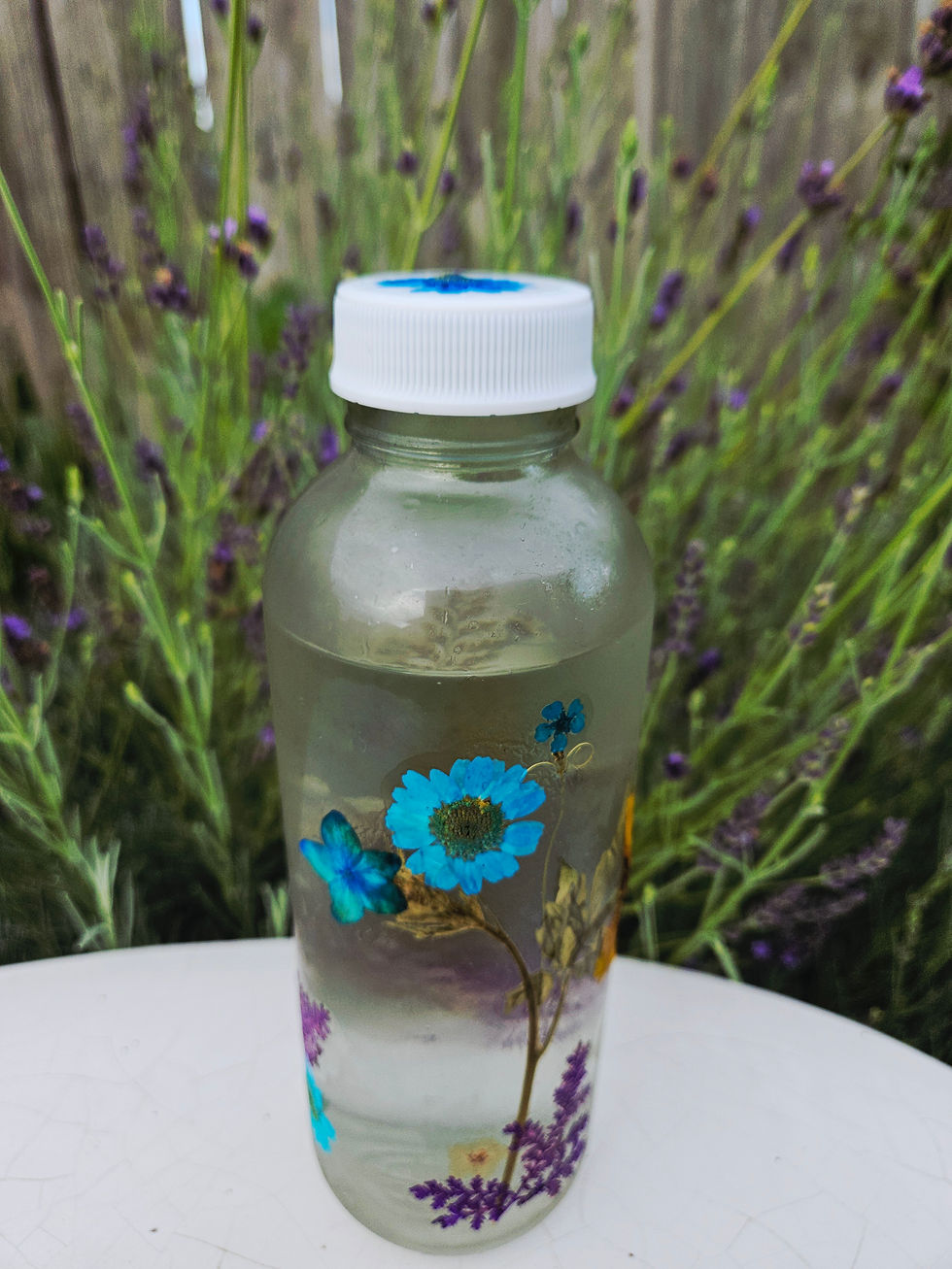 image of water bottle decorated in mod podge with real pressed botanicals