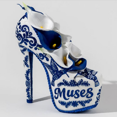 Krewe of Muses Blue and white porcelain-inspired Mardi Gras shoe with floral detailing and “Muses” lettering on the platform heel.