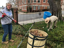Trinity volunteers raking leaves.