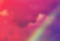Pink and purple clouds with a rainbow in the foreground.
